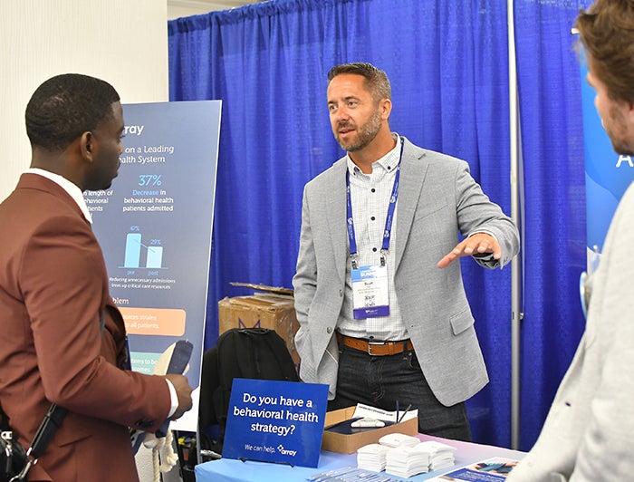 People at a conference booth