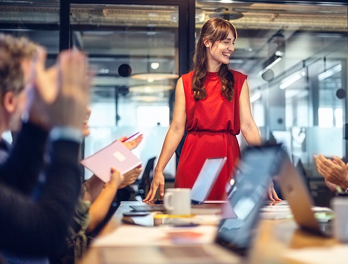 Female being applauded in a meeting