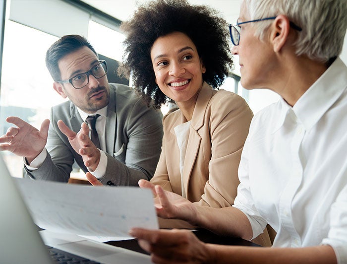 three people reviewing a document