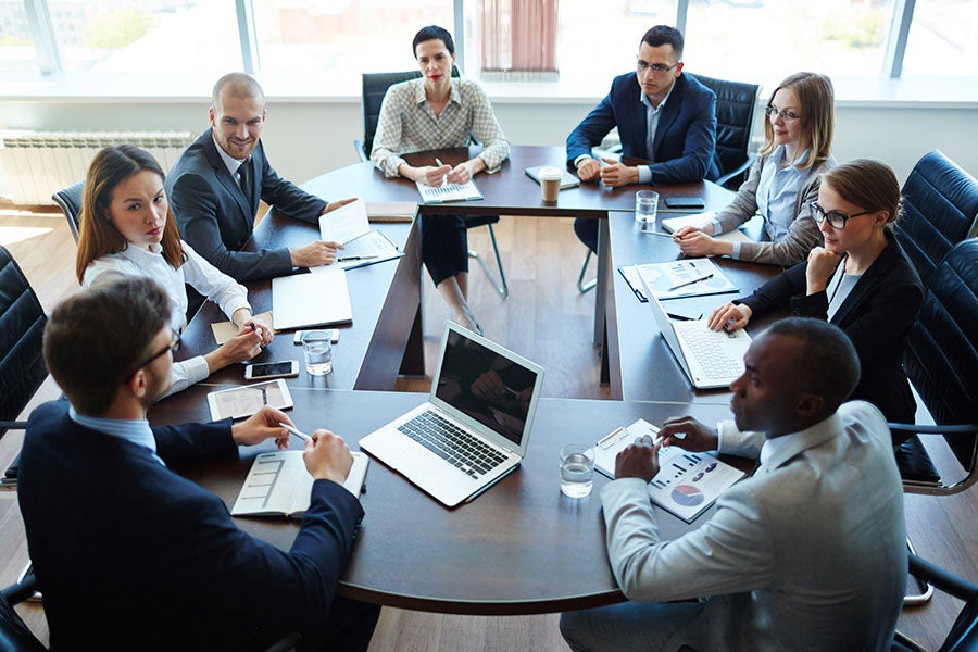 AHA Team Training taking place around a conference room table.