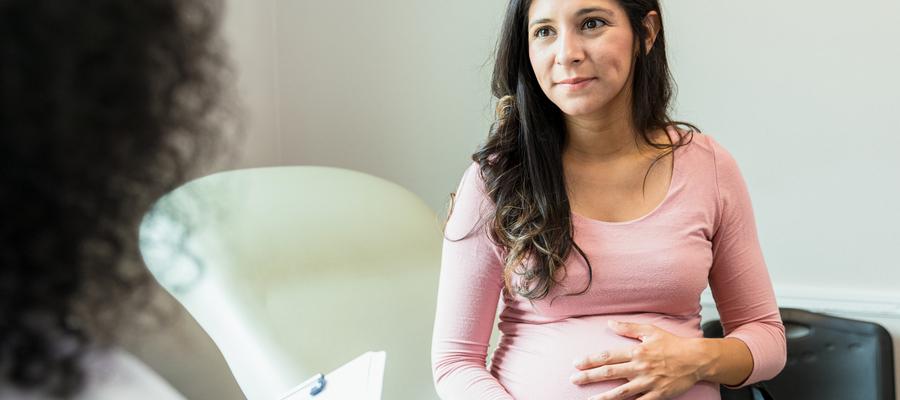 Expecting mother confers with physician