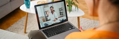Woman Having A Doctor's Appointment Online At Home stock photo